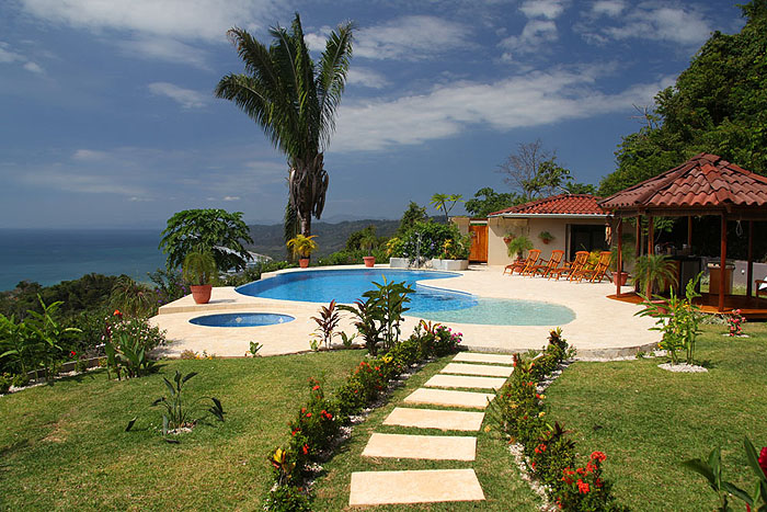Swimming pool and beautiful gardens of this malpais rental villa